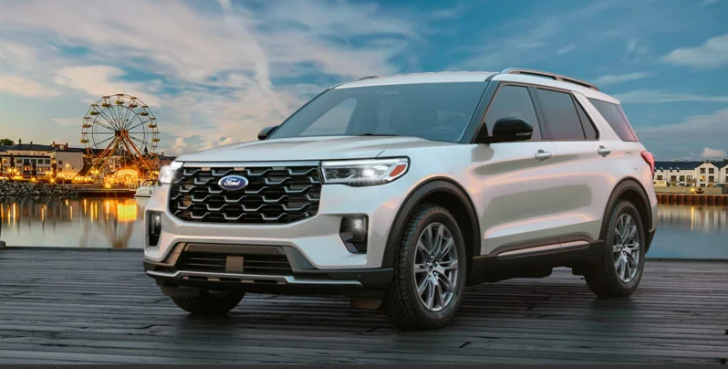 A photo of a 2026 Ford Explorer parked in front of a body of water with a Ferris wheel in the back.