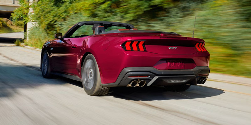2026 Red Ford Mustang back profile cruising on highway